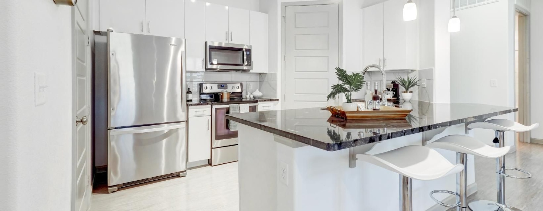a kitchen with white cabinets