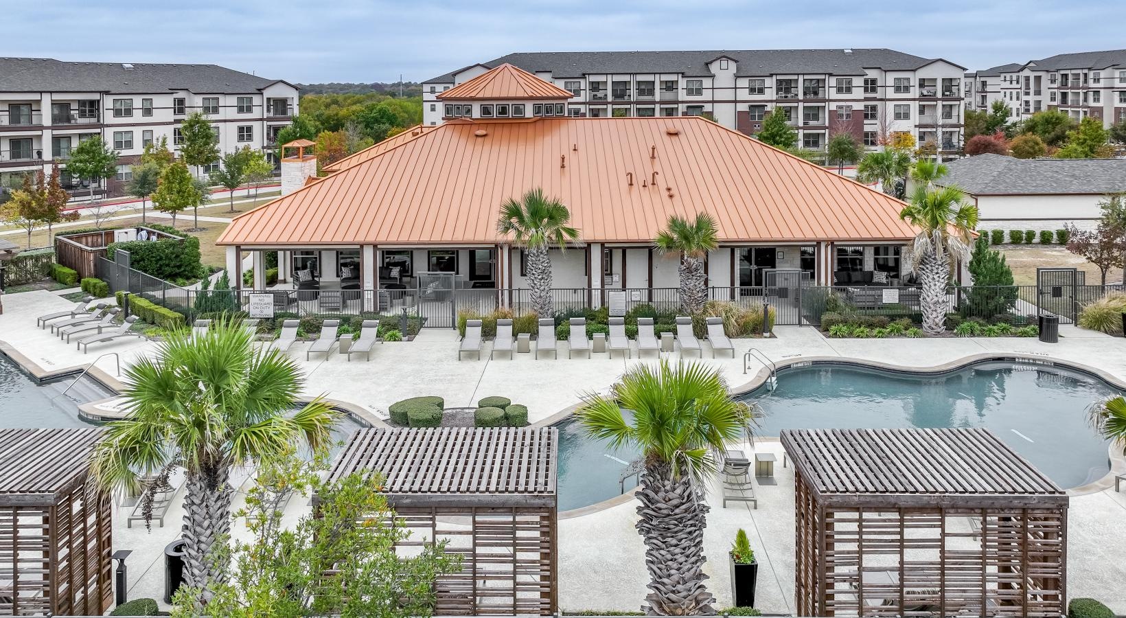 Find your perfect fit at Berkshire Preserve a building with a pool in front of it