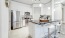 a kitchen with white cabinets