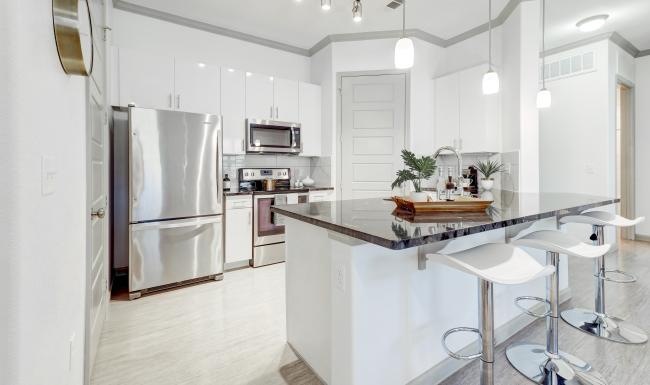 a kitchen with white cabinets
