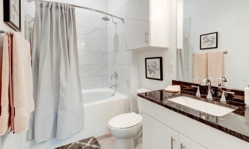 a bathroom with a tub sink and toilet