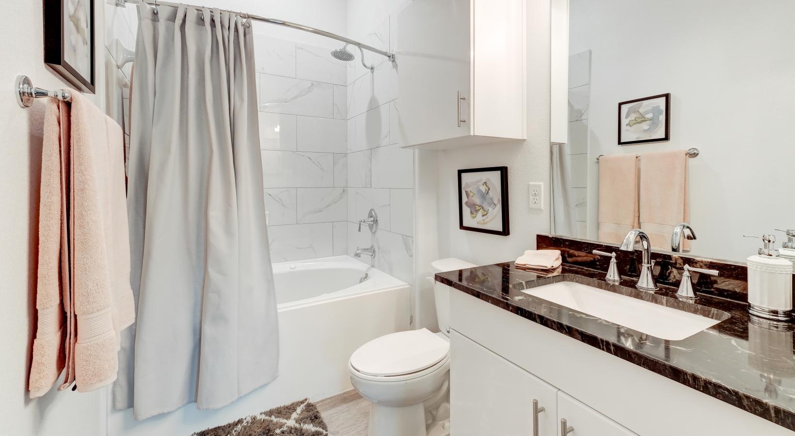 Spacious bathrooms with everything you need a bathroom with a tub sink and toilet