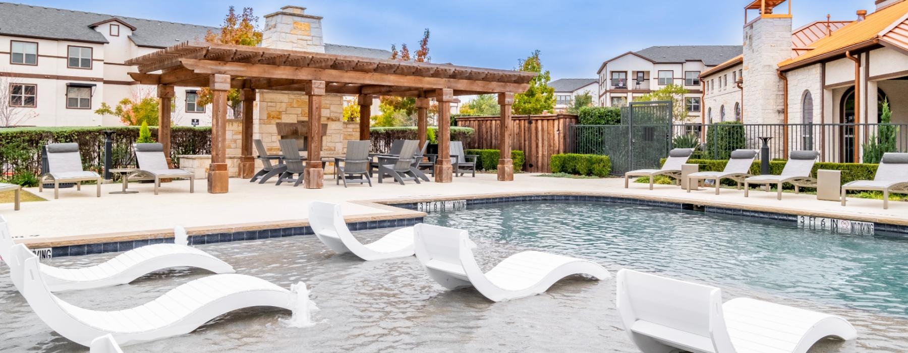 a pool with lounge chairs around it